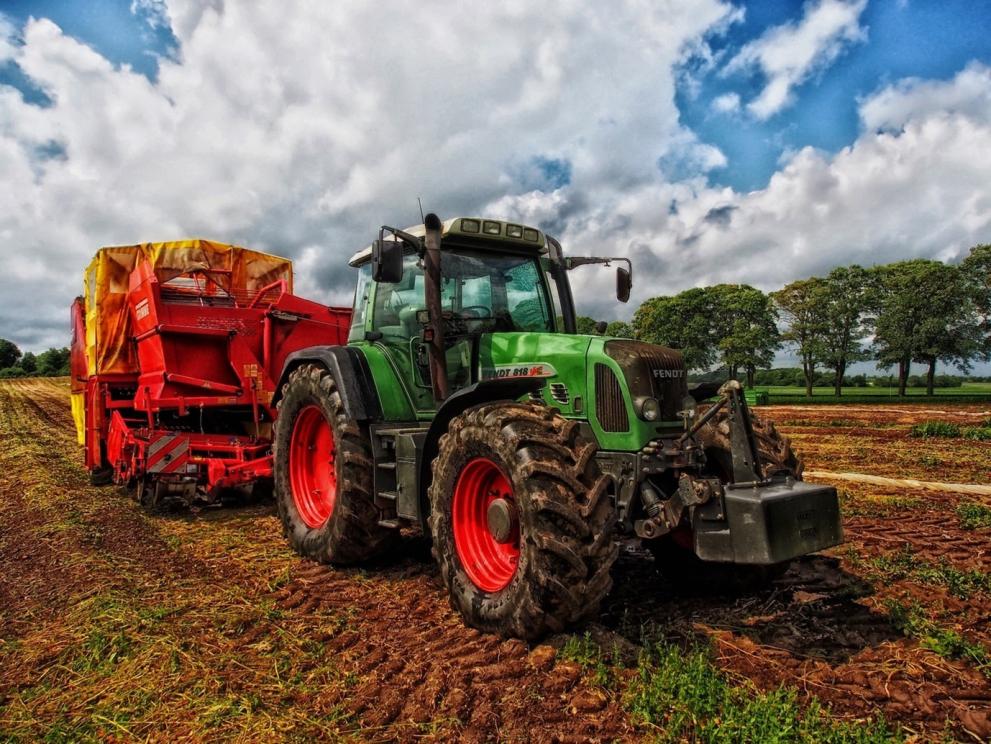 Green Tractor in Farming Field 