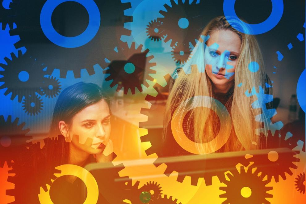 Orange and Blue background with multiple gears and two women speaking to each other 