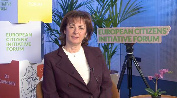 Olga Kikou, member of the group of organisers of Good Food for All in a suit sits during an interview  for the ECI Forum during ECI Day.