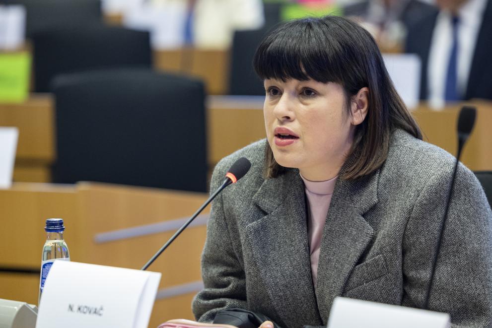 A professional photograph of Nika Kovač, the coordinator of the "My Voice, My Choice" campaign, speaking during an official hearing at the European Parliament on December 2, 2025.